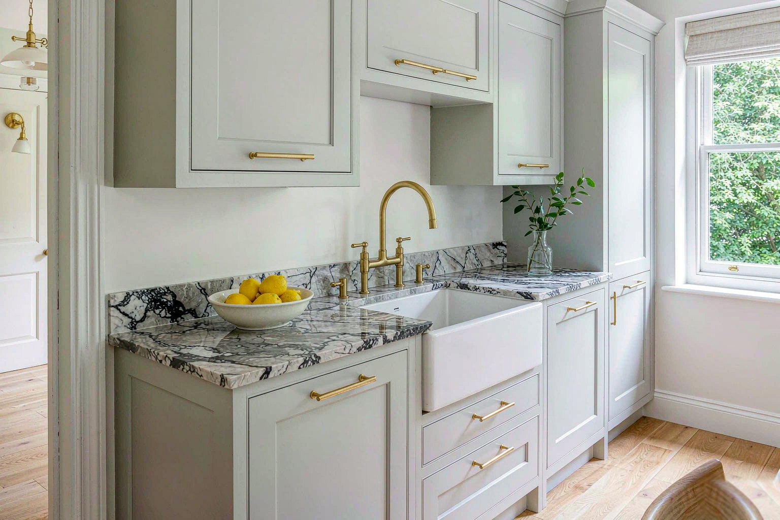 Home Modern British kitchen with pale units and brass fittings
