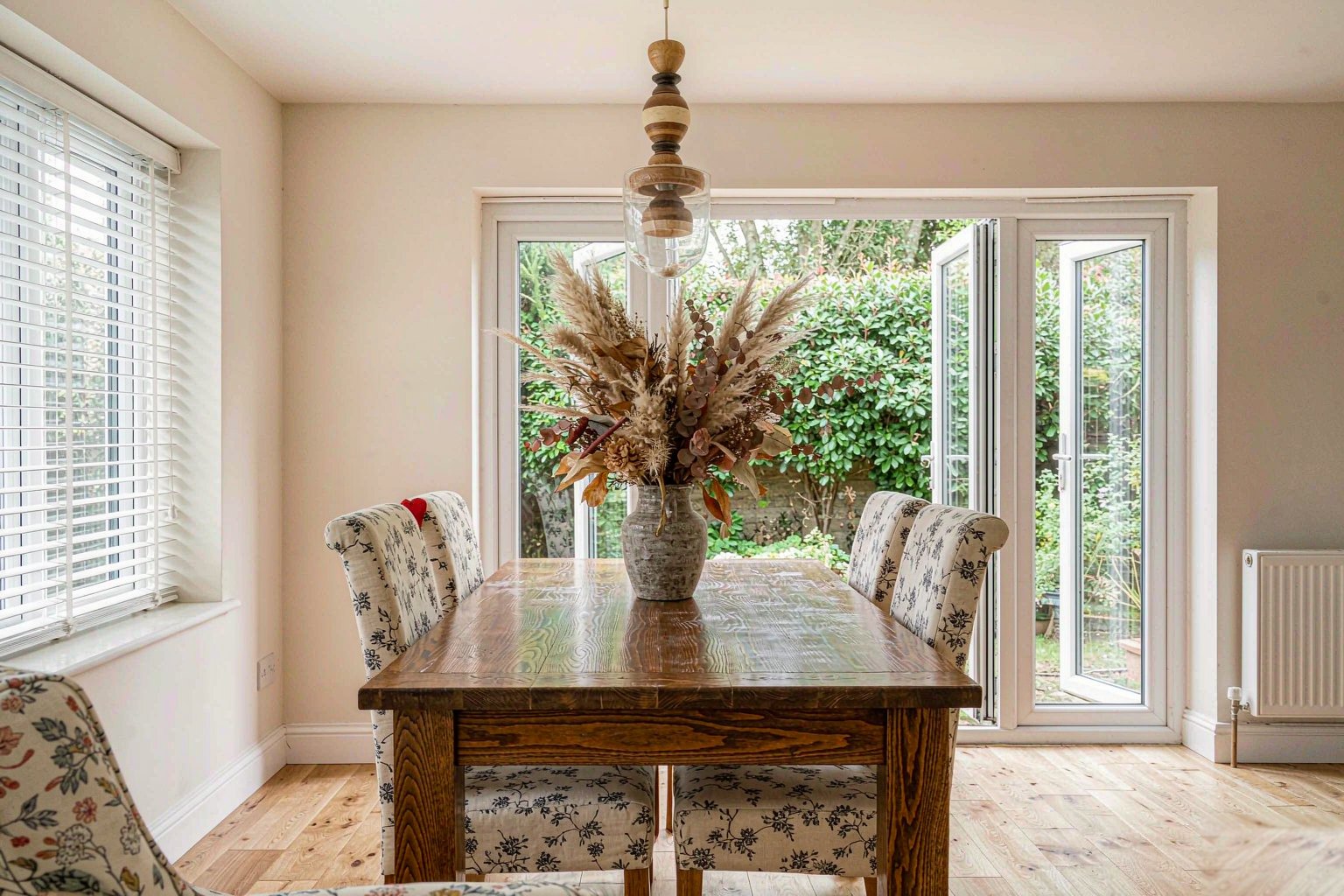 Home Open-plan dining area with doors onto a garden
