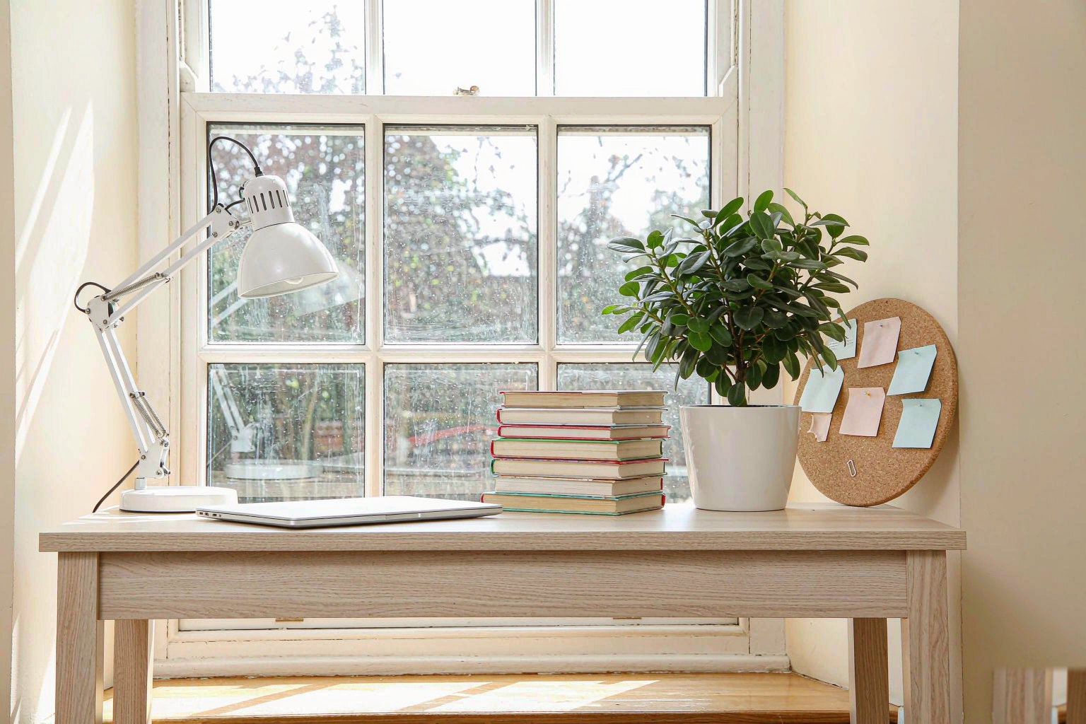 Home Bright home office corner with a desk and sash window